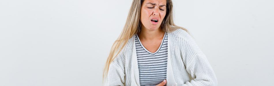 young lady in t-shirt, jacket suffering from stomach pain and l